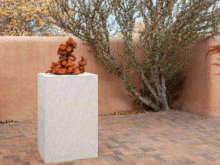 An iron Cumulus cloud sculpture by Karen LaMonte displayed outdoors.