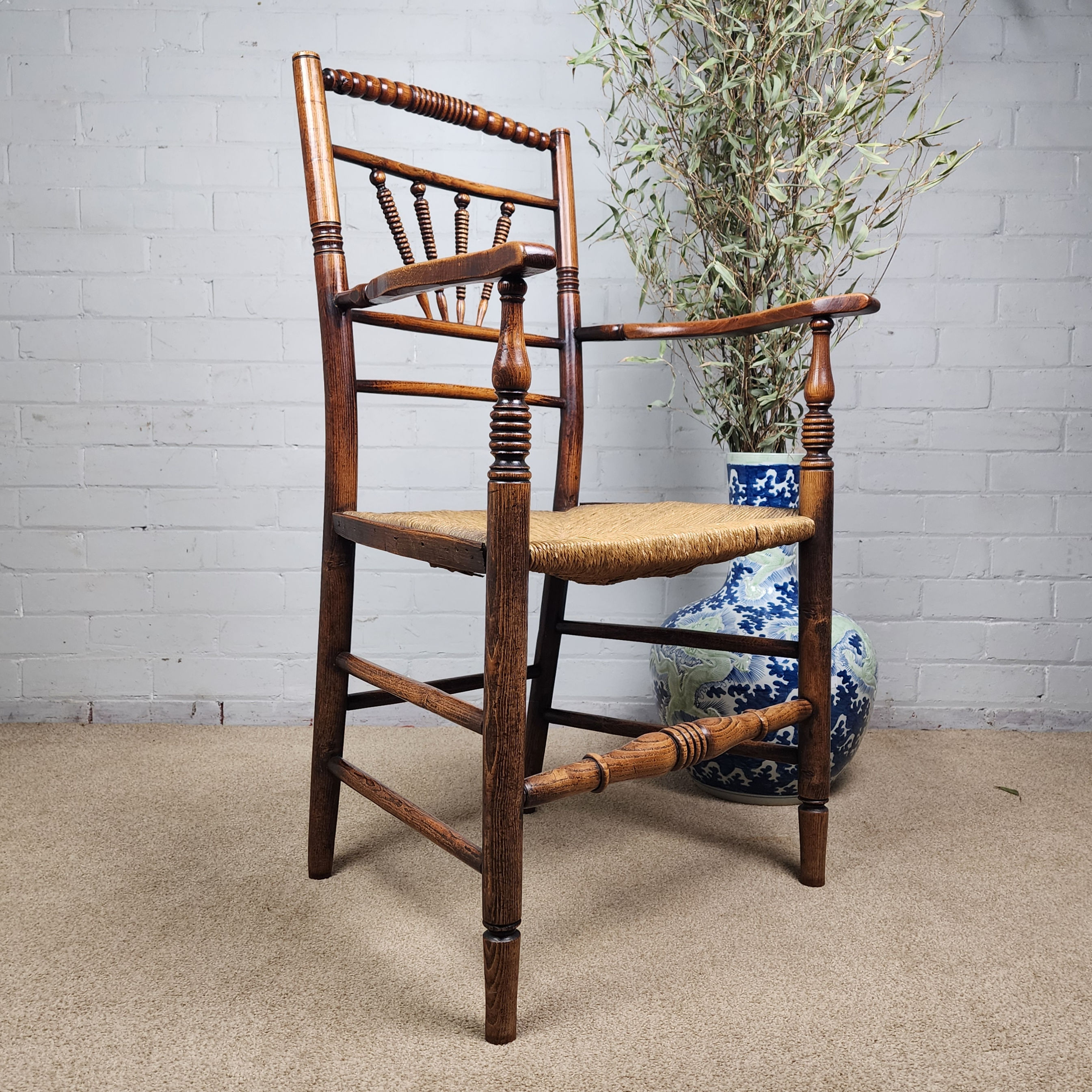 A George III Elm and Fruitwood Spindle Back Carver Chair