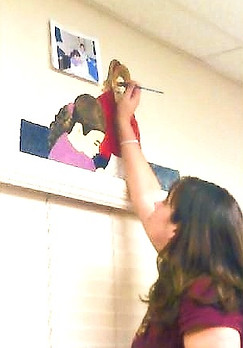 Woman painting mural