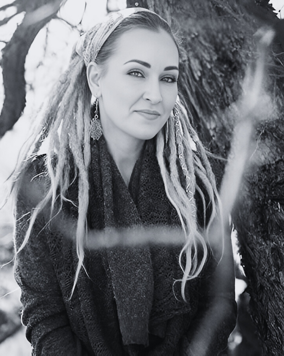 Woman leaning against a tree