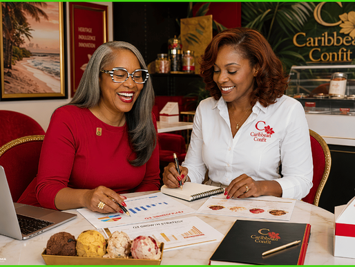 Two women review charts and notes at a Caribbean Confit table, smiling in a colorful red-and-gold office with brand signage.