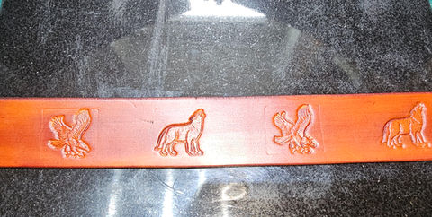 Bespoke handmade belt with alternate wolf and eagle stamped images