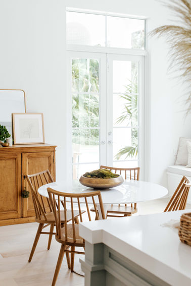 Light and airy eat-in kitchen in a Coral Gables home designed by Miami interior designer The Habitat Collective