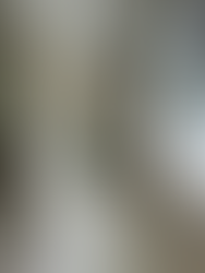 A dated bathroom with travertine walls and floors