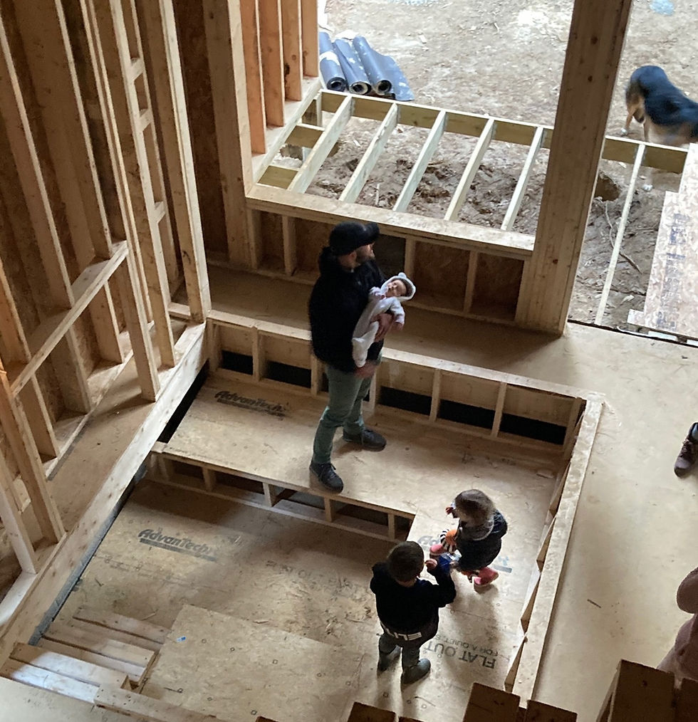 Family members inside The Carpenter's Cabin conversation pit during construction in Hocking Hills, Ohio