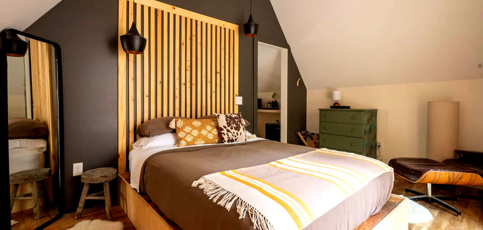 The loft primary suite at the Carpenter's Cabin