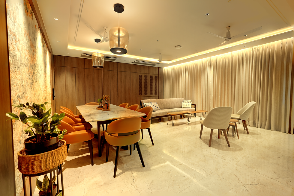 Modern dining room with orange chairs, marble table, sofa, curtains, and ceiling fans under warm lighting