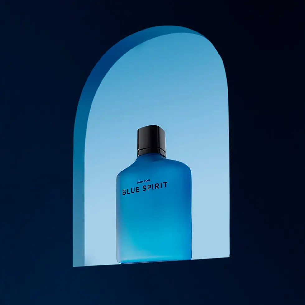 Blue perfume bottle labeled "Zara Man Blue Spirit" on a blue gradient background with an arched frame, evoking a calm and serene mood.