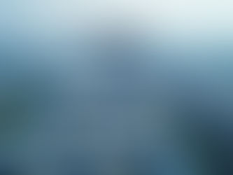 Aerial view of an industrial area with warehouses, roads, and canals, surrounded by green fields and residential neighborhoods.