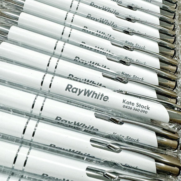 A box of white pens with Ray White branding.