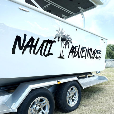 A boat with a decal reading Nauti Adventures.