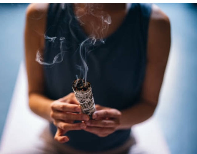 A person burning sage.