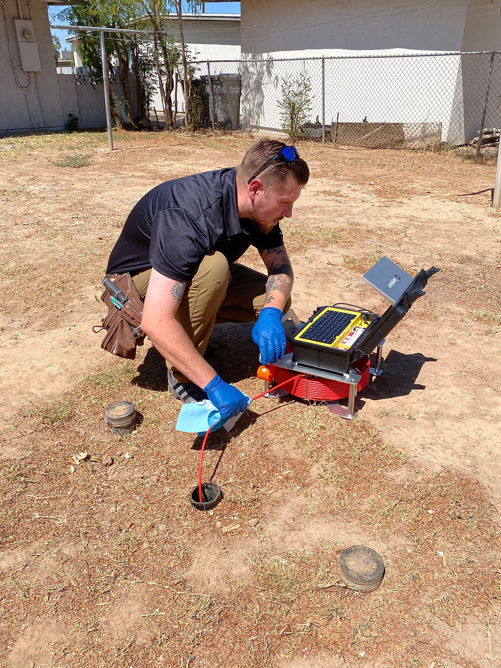 Professional home inspector performing a sewer scope inspection with a specialized camera to detect pipe cracks, tree root intrusion, and blockages, ensuring plumbing system safety.