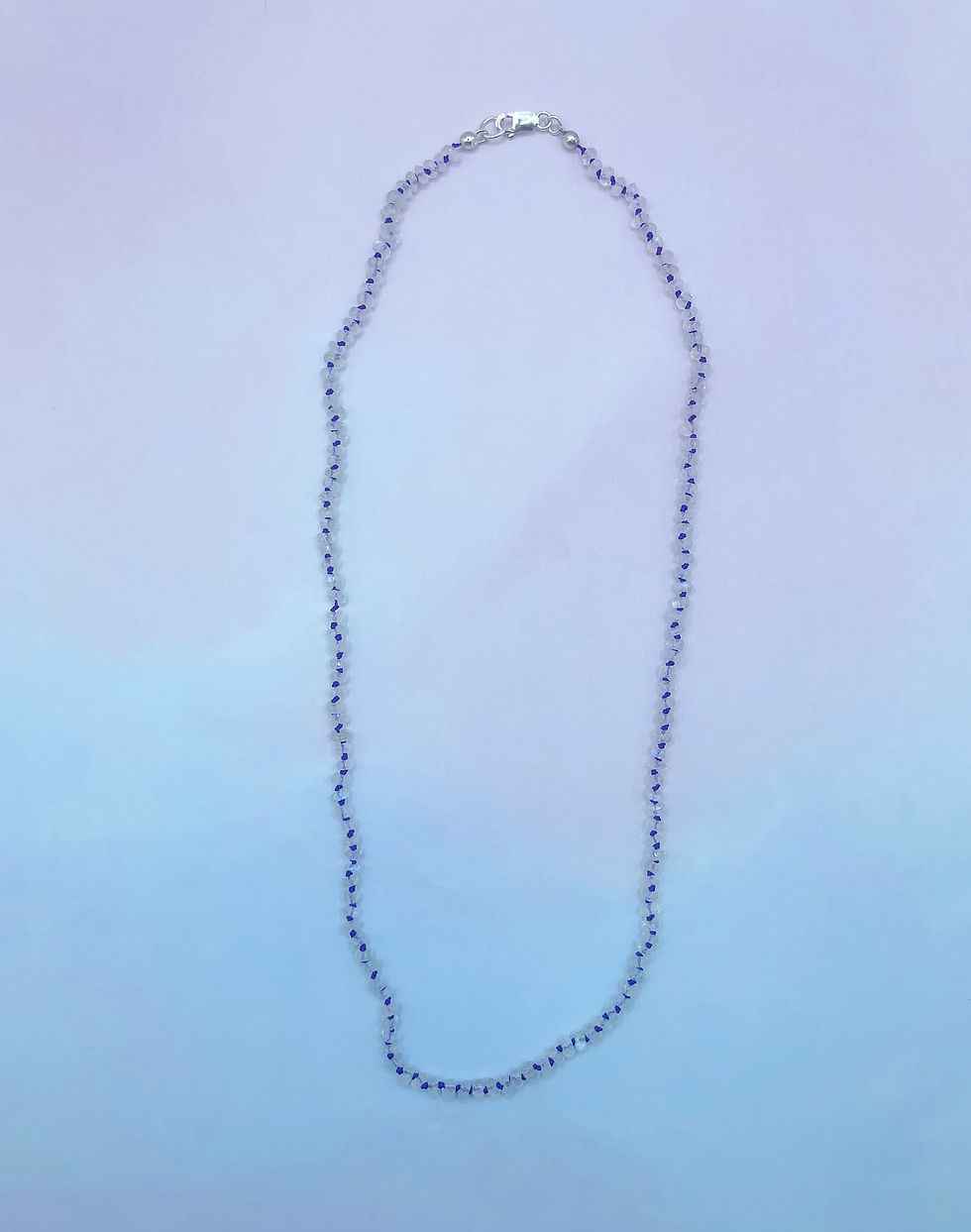 Thumbnail: Moonstone Bead Knotted Necklace on purple silk