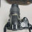 Thumbnail: A complete "What's Included" shot featuring the Nikon D3000 camera, 18-55mm VR lens, Nikon battery, MH-23 quick charger with