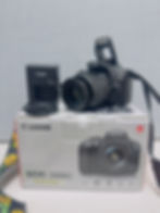 Canon EOS 2000D DSLR camera with the EF-S 18-55mm kit lens, box, strap, and accessories included in the complete photography