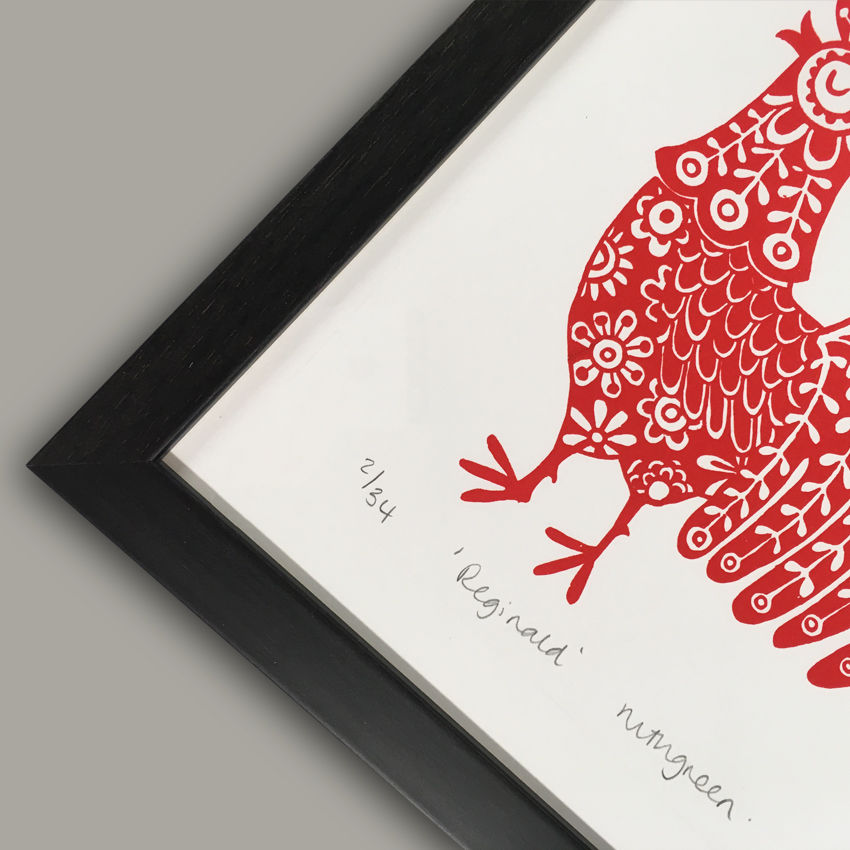 a framed picture of a red rooster says reginald ringgreen
