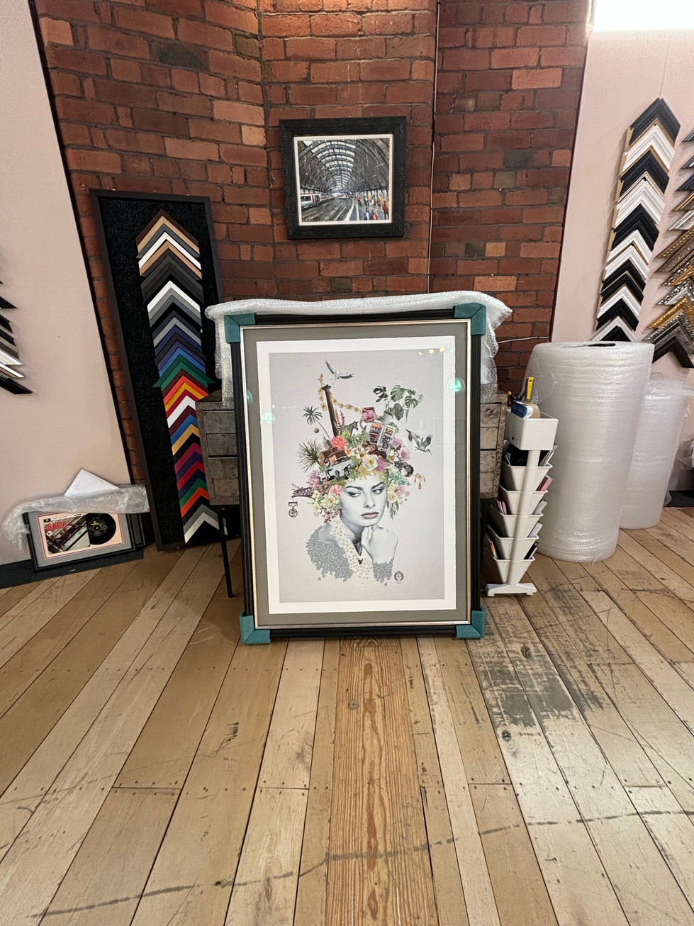 a framed picture of a woman with flowers on her head