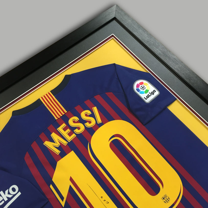 a framed jersey with the name messi on it
