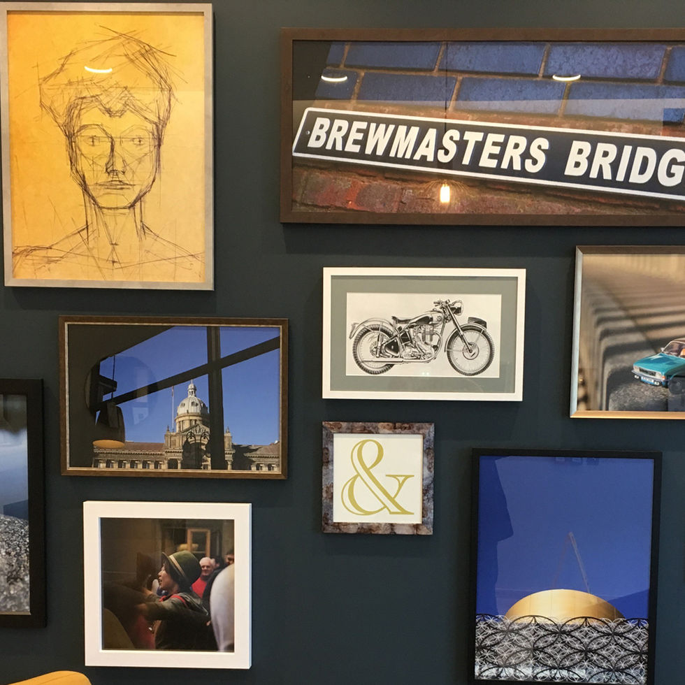 a row of framed pictures on a wall with a sign that says brewmasters bridge