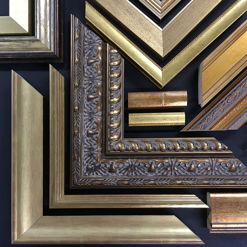 a collection of gold and silver picture frames on a black background
