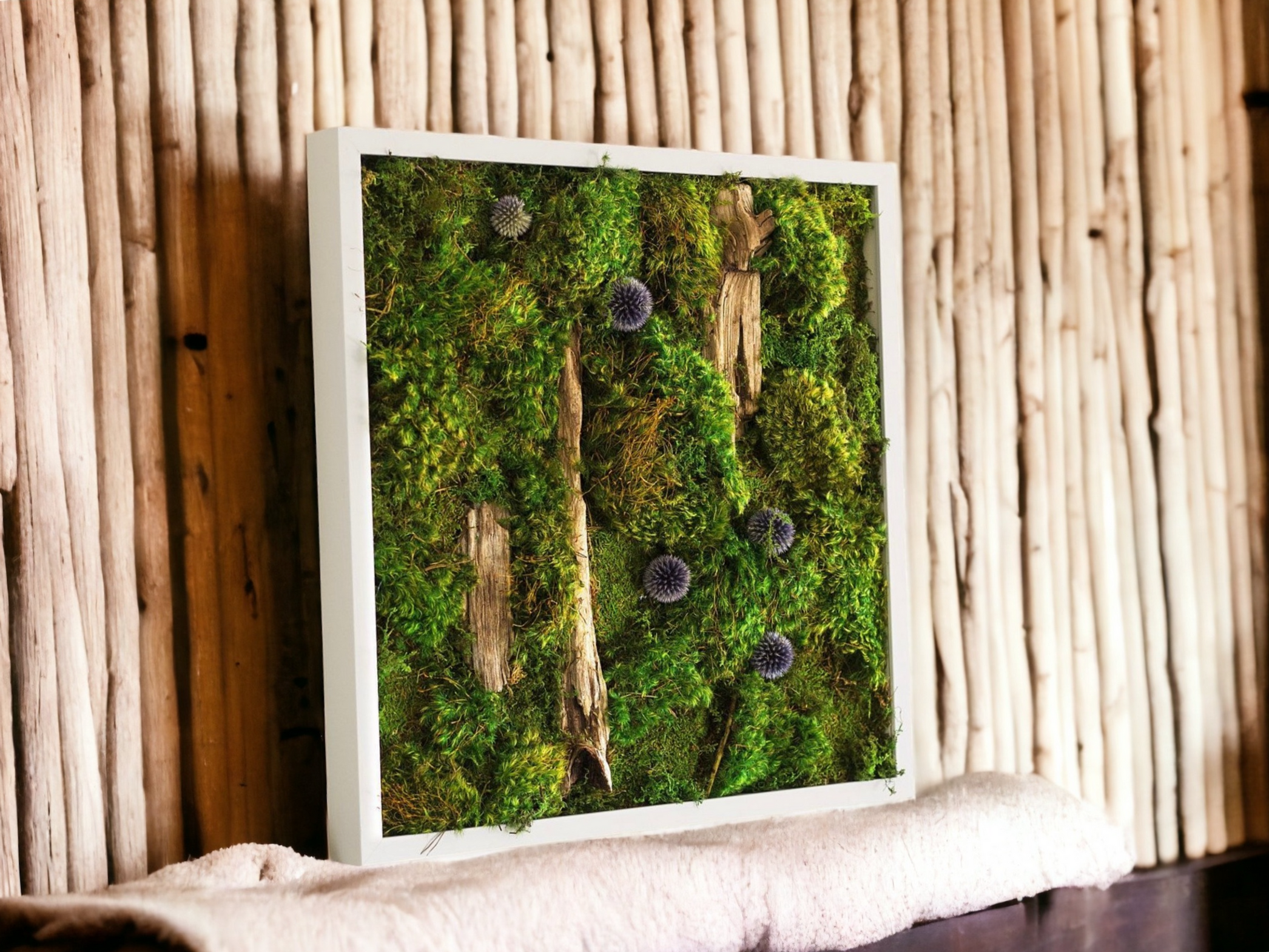 Framed moss wall art with driftwood, blue thistles, and preserved moss