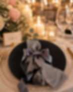 Elegant table setting with grey favor, flowers, and candles