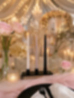 Elegant table setting with candles and pink roses