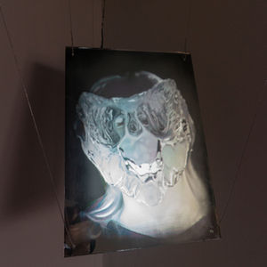 Close-up of patte de verre silkworm cocoon with skeletal form, symbolizing techno-biological identity