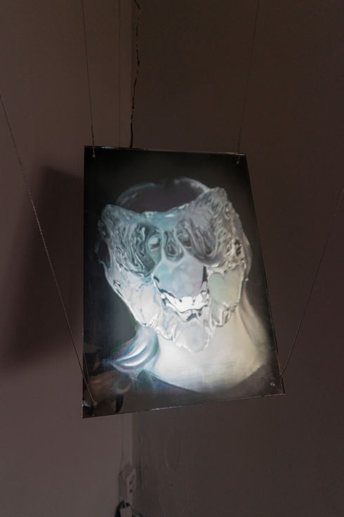 Close-up of patte de verre silkworm cocoon with skeletal form, symbolizing techno-biological identity