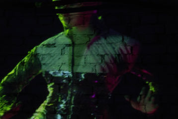 Charter X projected in a dark gallery space, evoking deep space immersion and speculative futurism