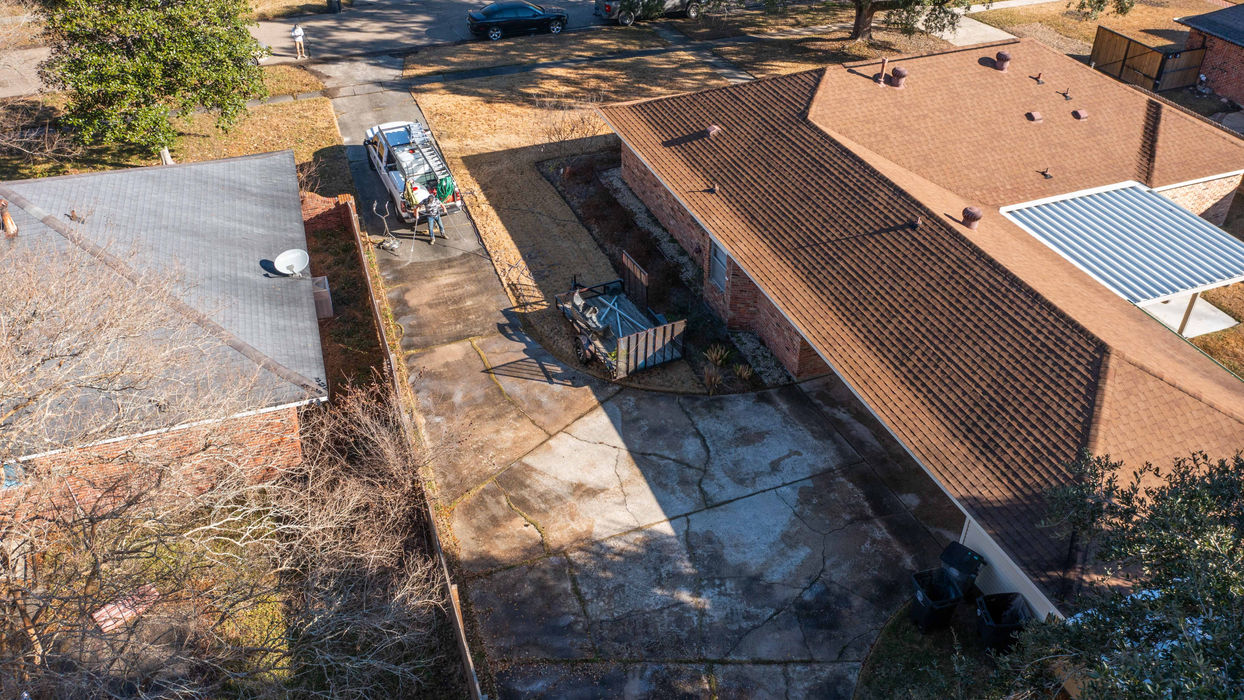 Aerial view of house and driveway, showing roof and cleaning equipment