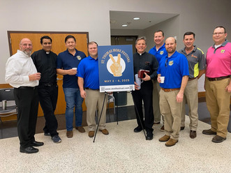 Priests and men promoting "ST. THOMAS MORE FESTIVAL" with peace sign logo.