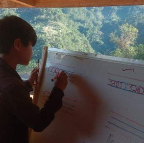 har-lo-student-writing-on-board.jpeg