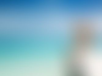 A beautiful girl sits by the beach after losing weight using Harmony Health Clinic's body sculpting program