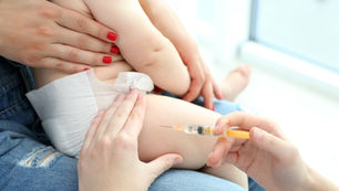 a baby is forced into getting vaccinated with dangerous compounds
