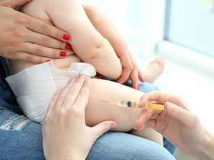 a baby is forced into getting vaccinated with dangerous compounds