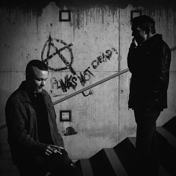 Gustav Müller and Christoph Rebhan in front of an Anarchy symbol