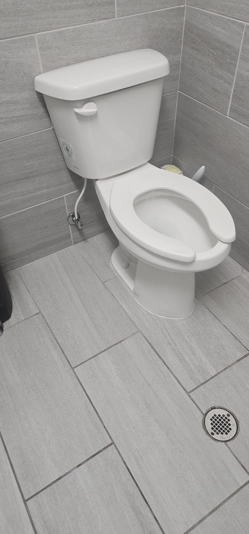 A damp, dimly lit shower stall with visible mildew and grime, symbolizing a common source of unpleasant odors. This image relates to solutions for eliminating bad smells, such as finding a good odor eliminator for the bathroom and methods for removing trapped odors from porous surfaces like wood furniture, often found in nearby spaces affected by the shower's stench. Focus on cleaning and odor removal products.