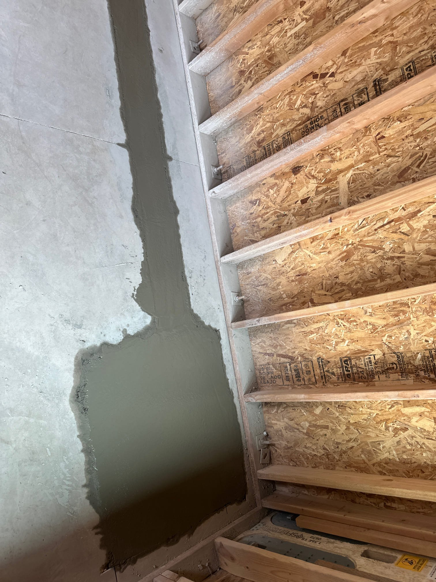 Image depicting domestic backflow, potentially showing storm sewage or wastewater reversing flow into a home. A backflow prevention device may be visible, illustrating its role in preventing contamination of potable water supplies from sewage backups.