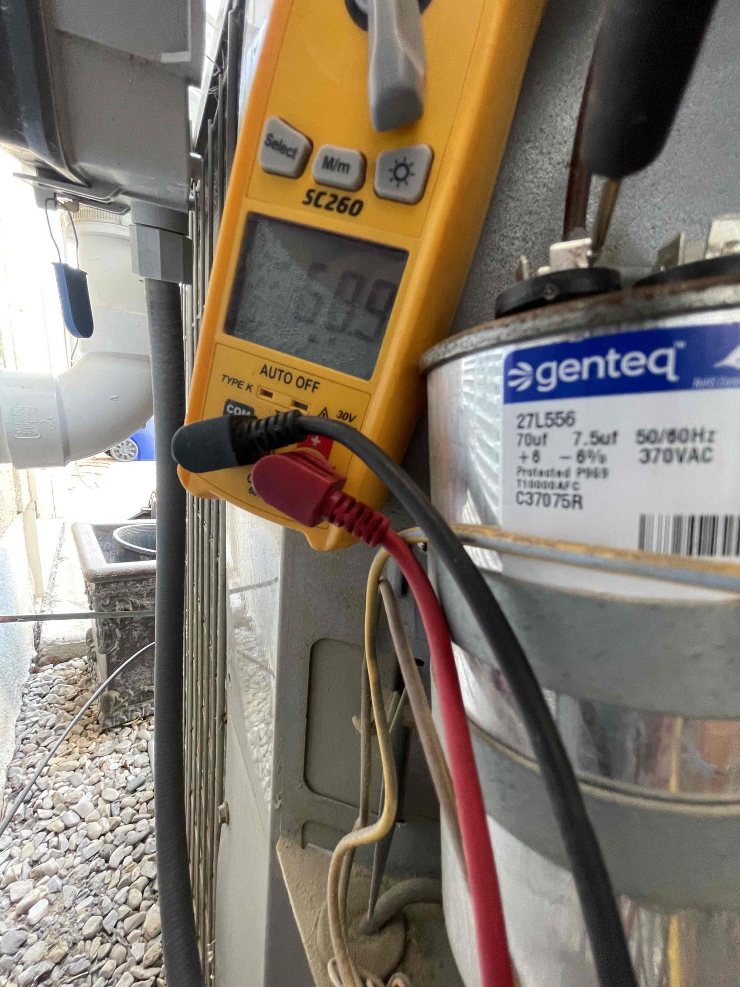 Image depicting residential AC service. A qualified residential HVAC contractor, representing a local HVAC company, is servicing an air conditioning unit at a home. Ensuring efficient and reliable cooling for your home. Residential HVAC company near me.