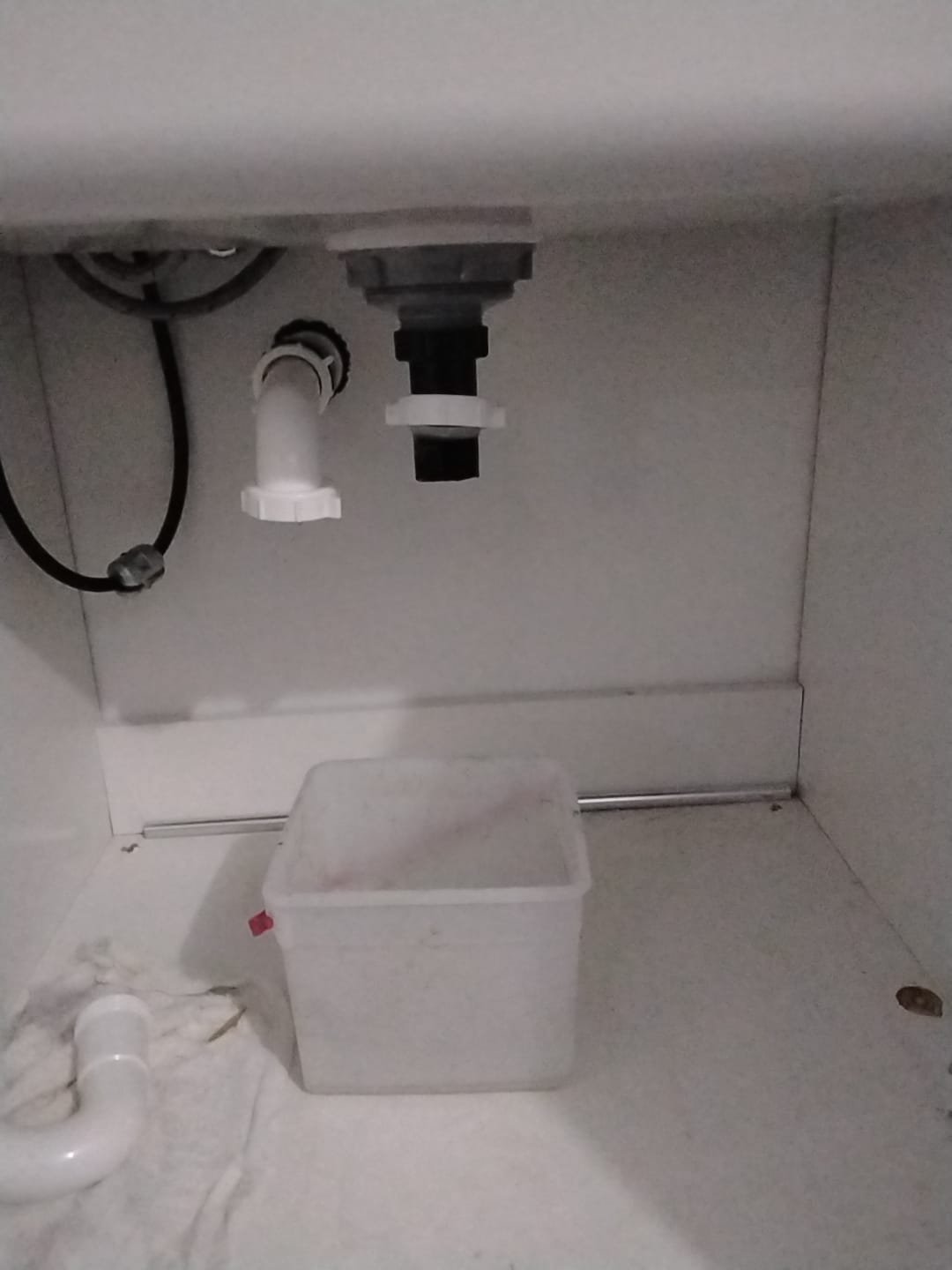 Bathroom problems: A damp bathroom scene hinting at mold treatment on the ceiling, a dripping sink, and a foul odor, suggesting potential plumbing and mold issues.