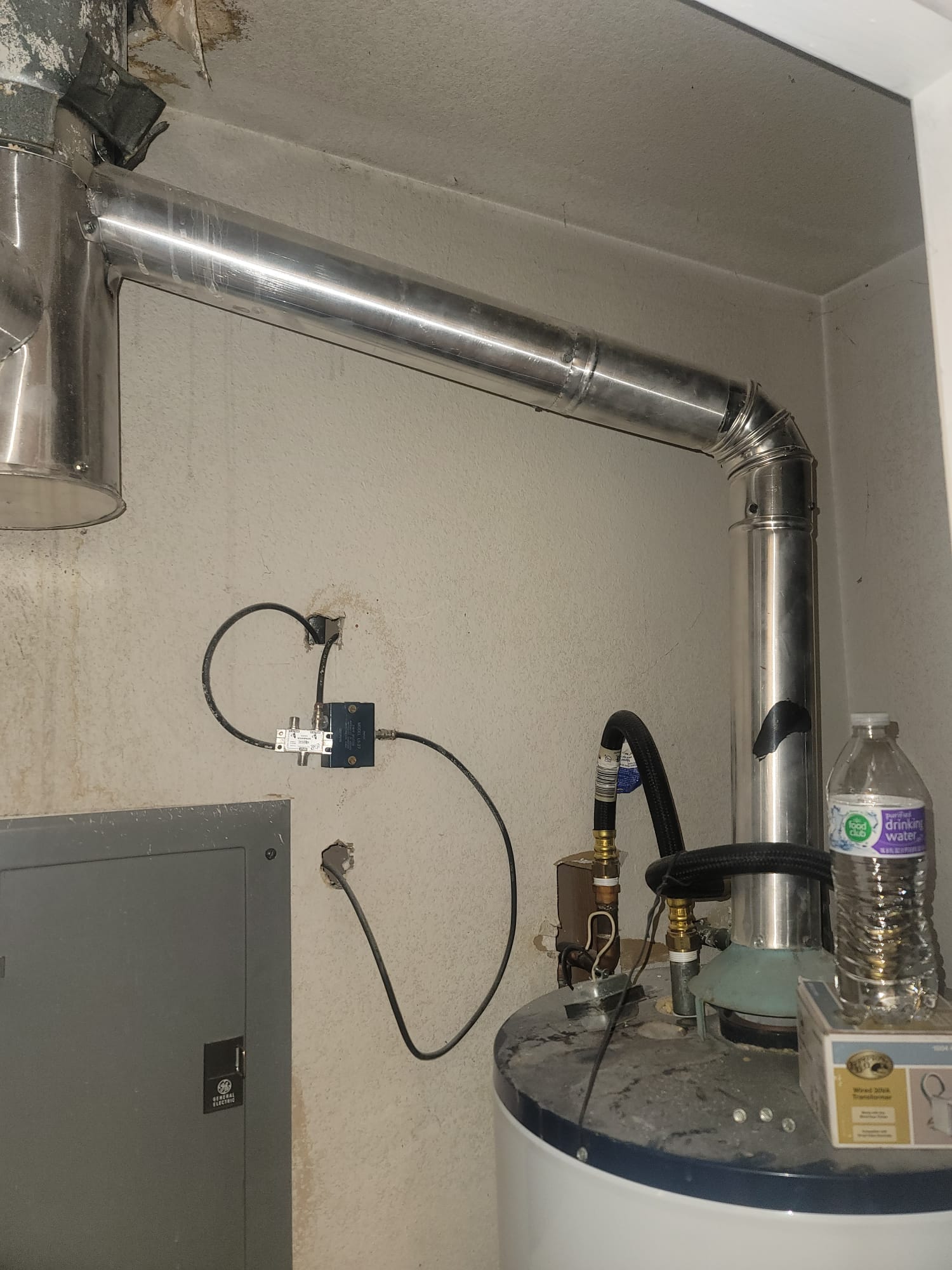 Image depicting a concerned homeowner inspecting minor water damage, possibly a small stain or leak. The visual subtly questions, 'Should I file a home insurance claim?' with considerations for limited water damage coverage and if homeowners insurance will cover the costs. The image conveys uncertainty about whether the damage warrants a claim.