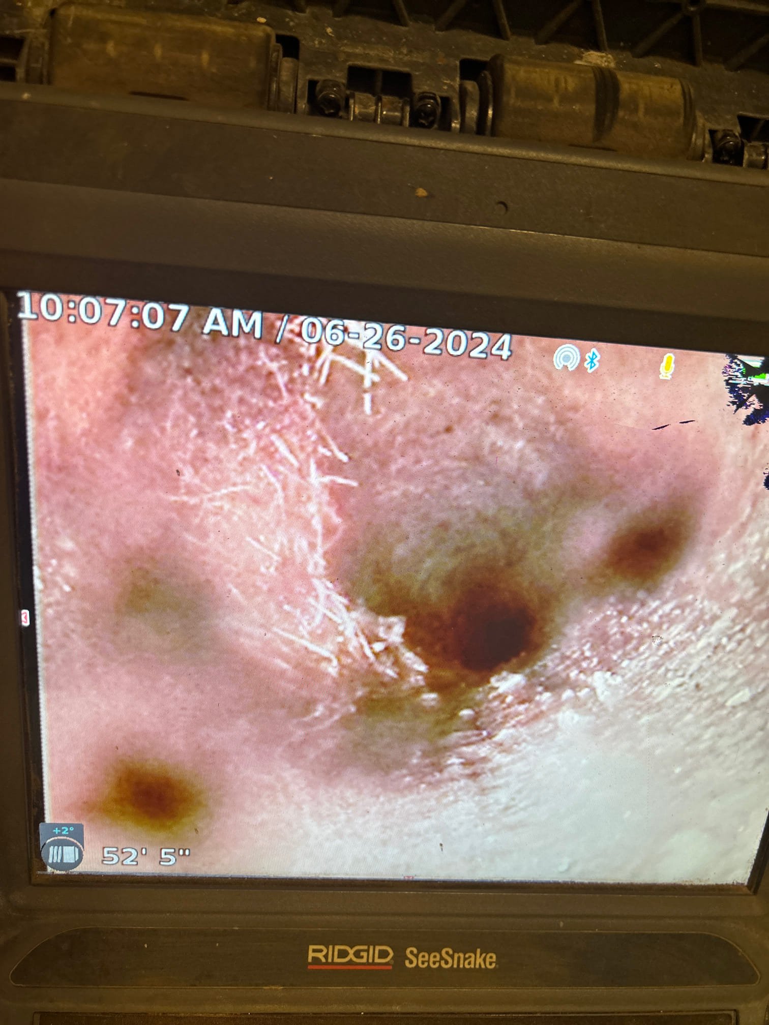 A drain stopper is displayed, a common cause of clogged drains. Contact 'drain cleaning near me' services to help remove hair and debris buildup or use a 'snake drain' tool for effective clog removal.