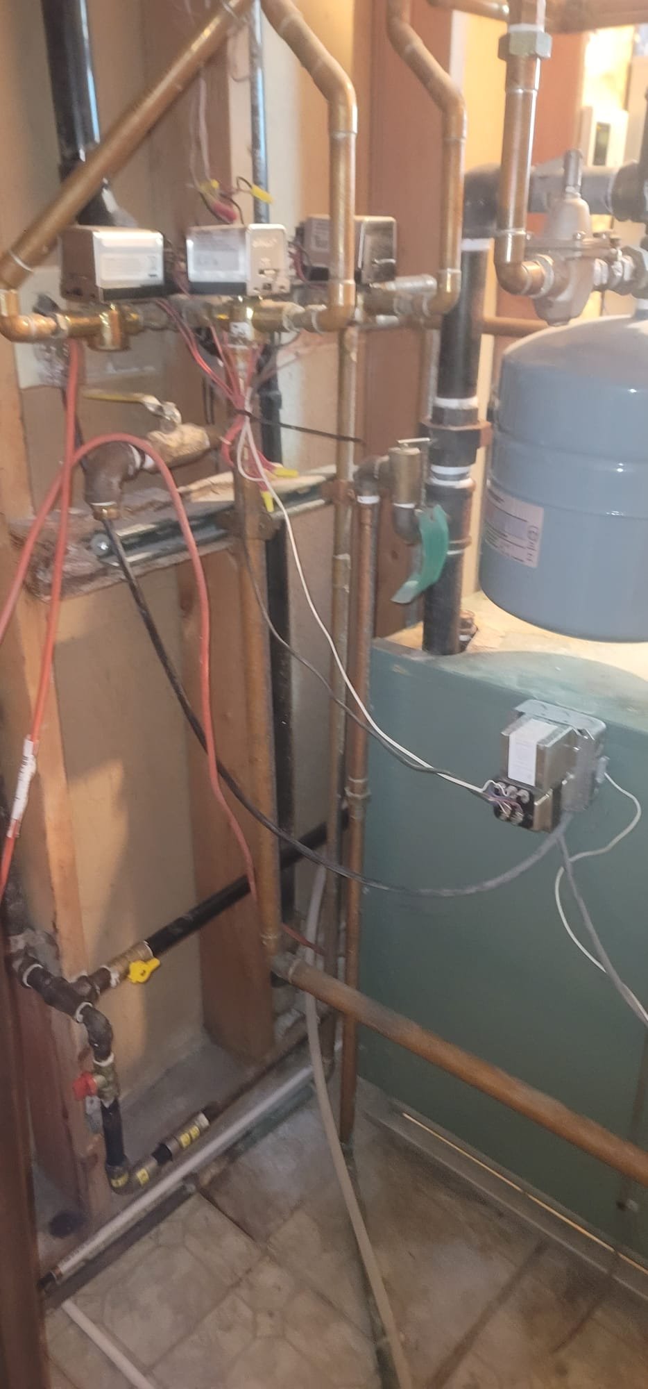 Commercial HVAC technician servicing gas-fired steam boilers. Image shows skilled worker cleaning pipes, ensuring efficient and safe operation of industrial air conditioning systems. Expertise in boiler maintenance and pipe cleaning for optimal performance.