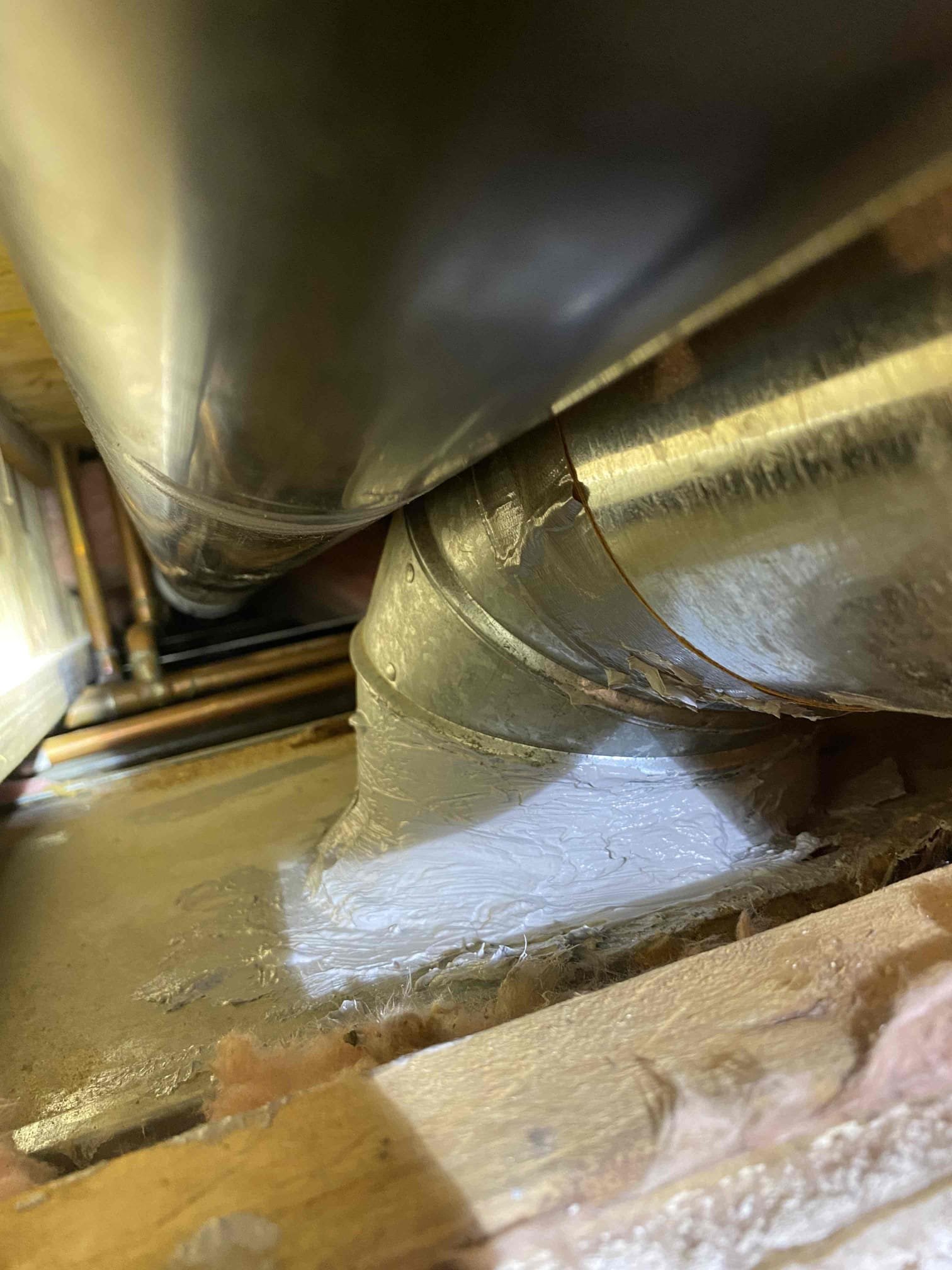 Professional duct cleaners inspecting and cleaning air conditioning ductwork to improve air quality and HVAC efficiency. Regular duct cleaning is essential for homes with traditional air conditioning systems, but ductless AC systems offer an alternative solution without the need for ductwork.