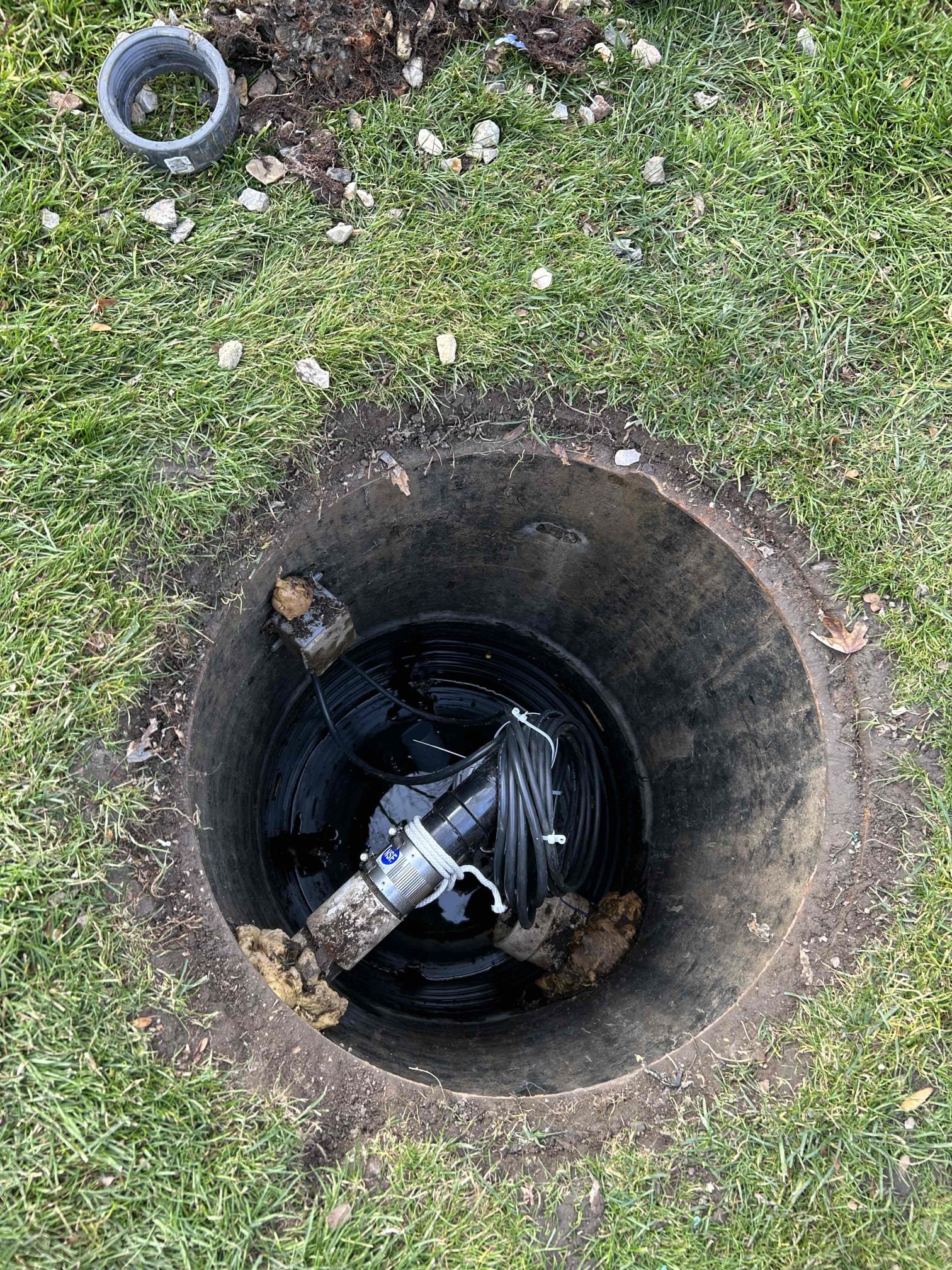 Image depicting sewage overflow cleanup in a backyard, highlighting professional sewage backup recovery services. Related to sewage backup recovery service 1 and sewage overflow in backyard scenarios.