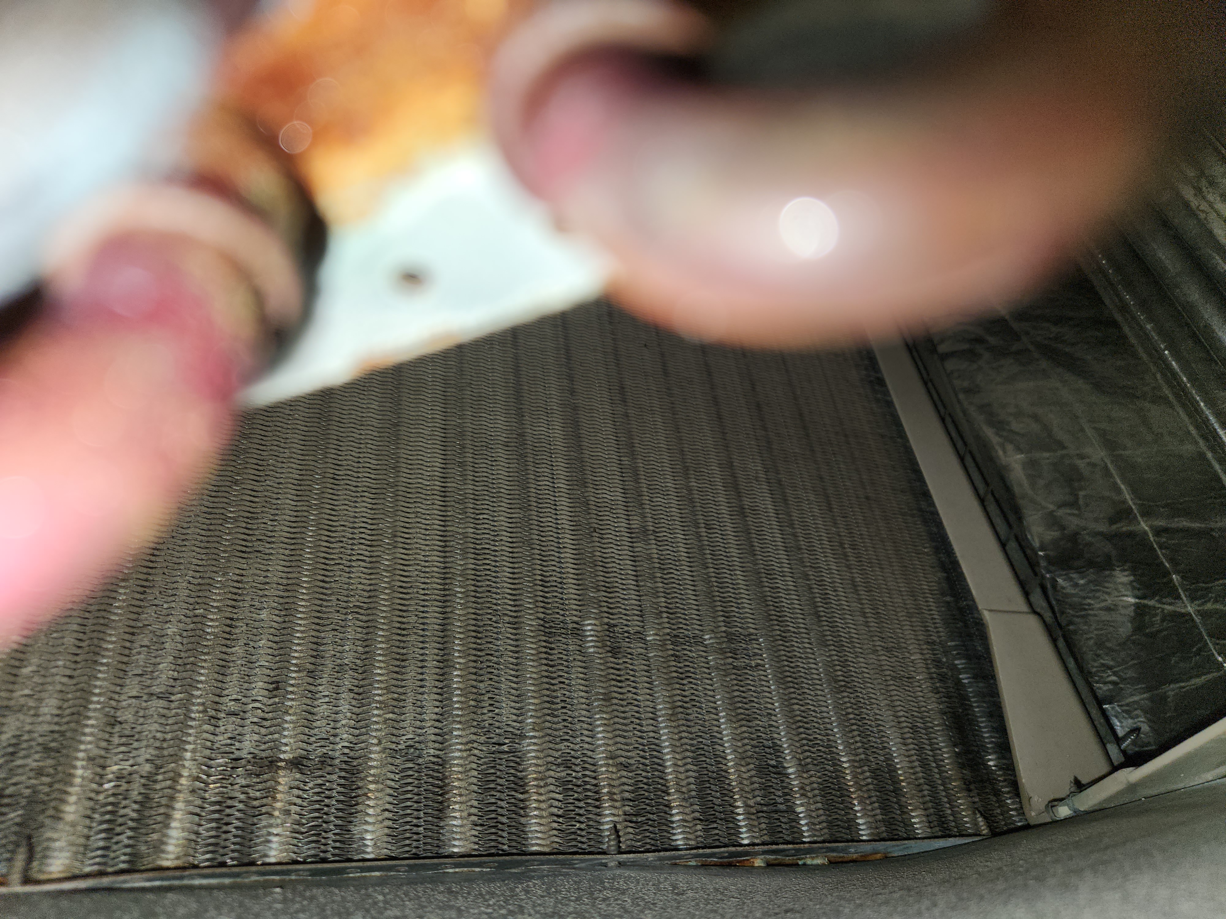 HVAC technician performing a residential air conditioning tune-up. Regular AC maintenance, as recommended by Goodman air conditioning reviews, ensures optimal performance and efficiency. Schedule your tune-up service today!