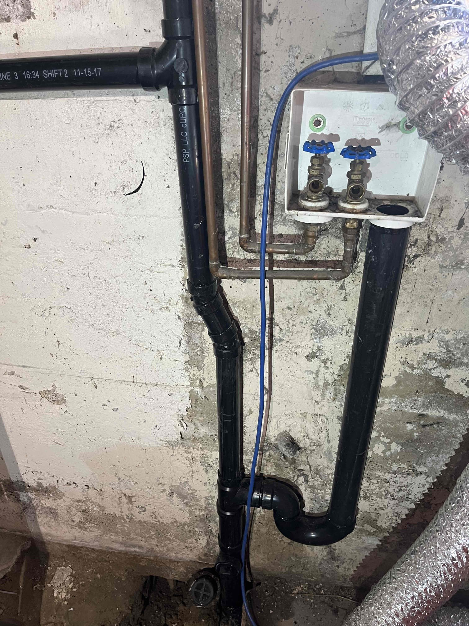 A typical bathroom stall interior. Focus is drawn to the empty toilet paper dispenser and the overflowing, clogged toilet, hinting at potential plumbing issues.