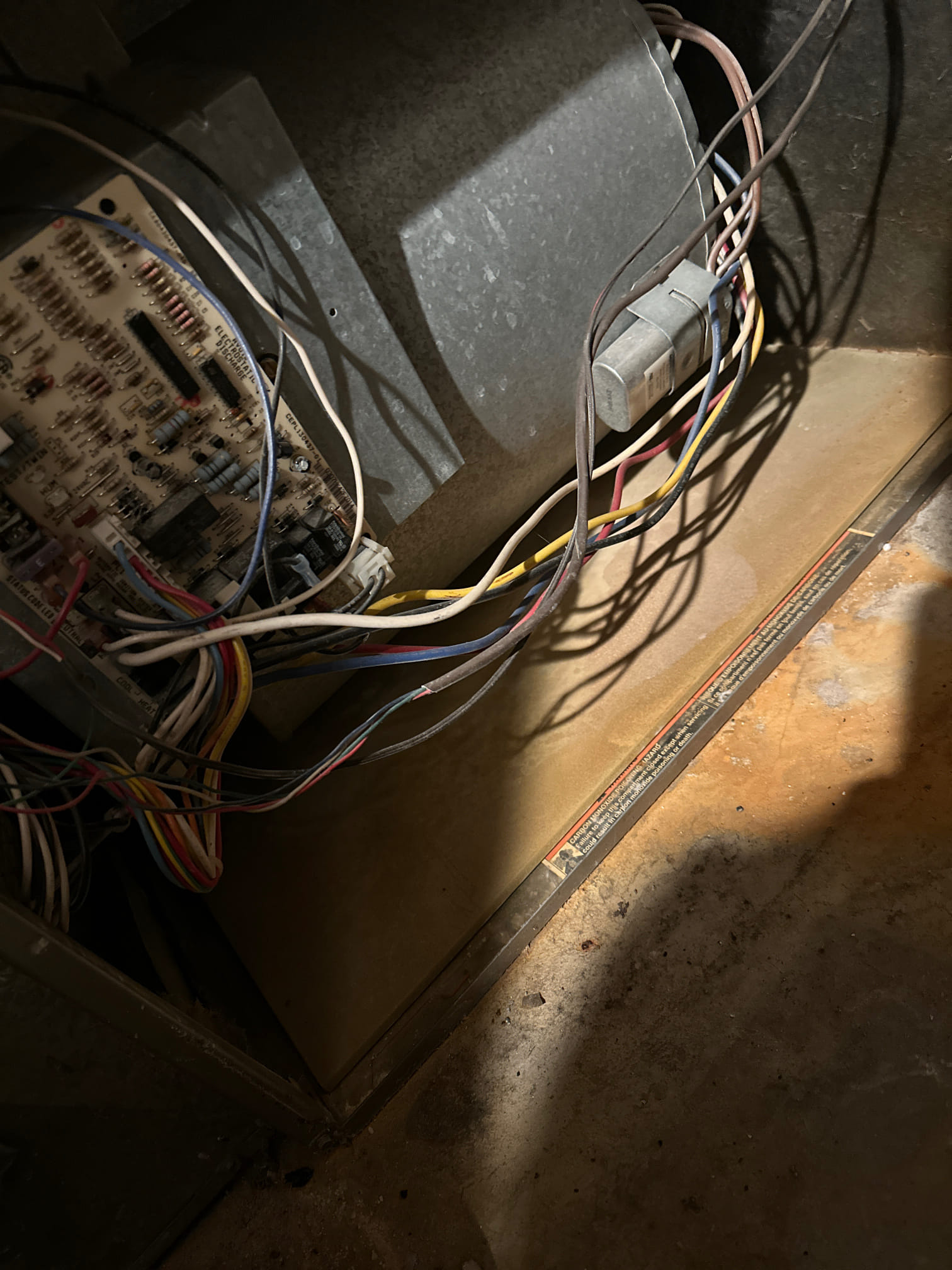 Close-up of a ceiling furnace highlighting the air filtration system, with a view of the gas valve. Illustrates clean air technology and furnace maintenance for optimal indoor air quality.